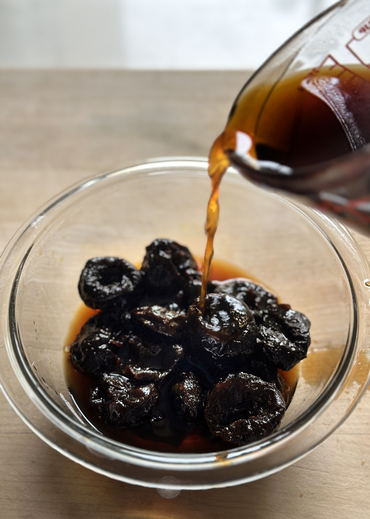 pouring coffee over prunes to soak