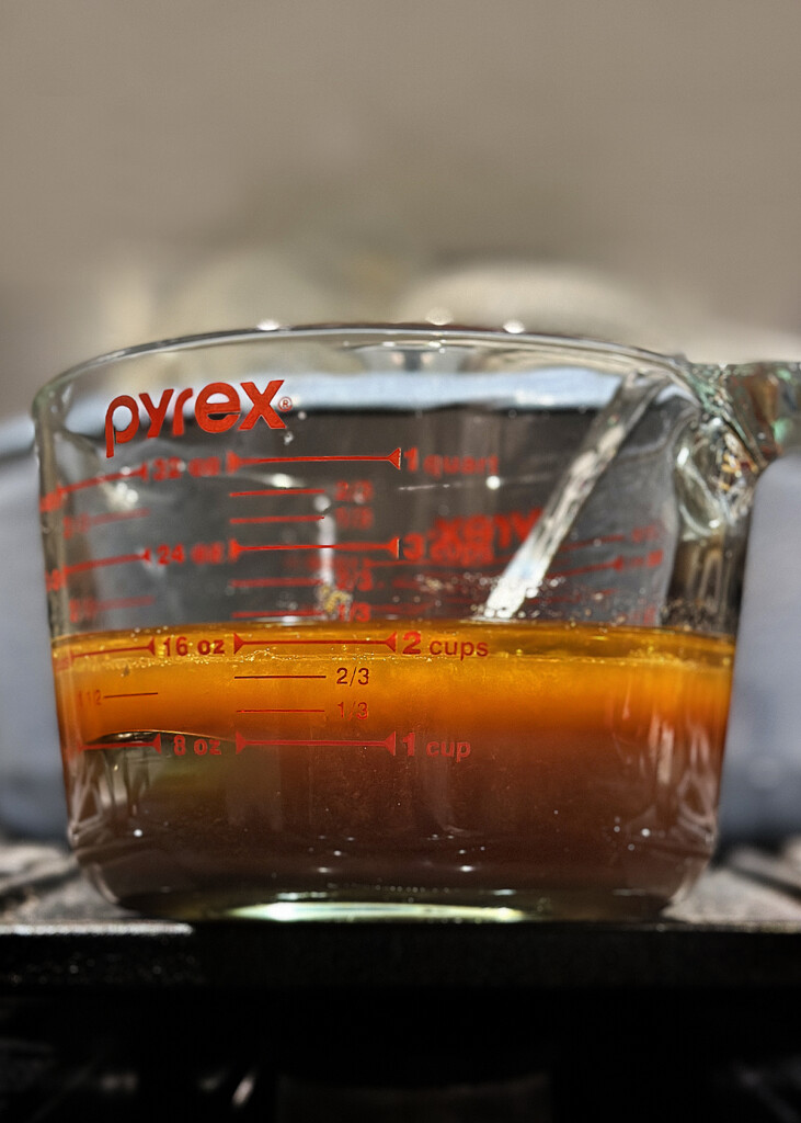 beef broth/stock in measuring cup with fat