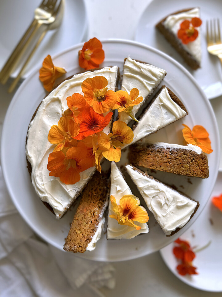 carrot cake, whole cake sliced on white cake plate