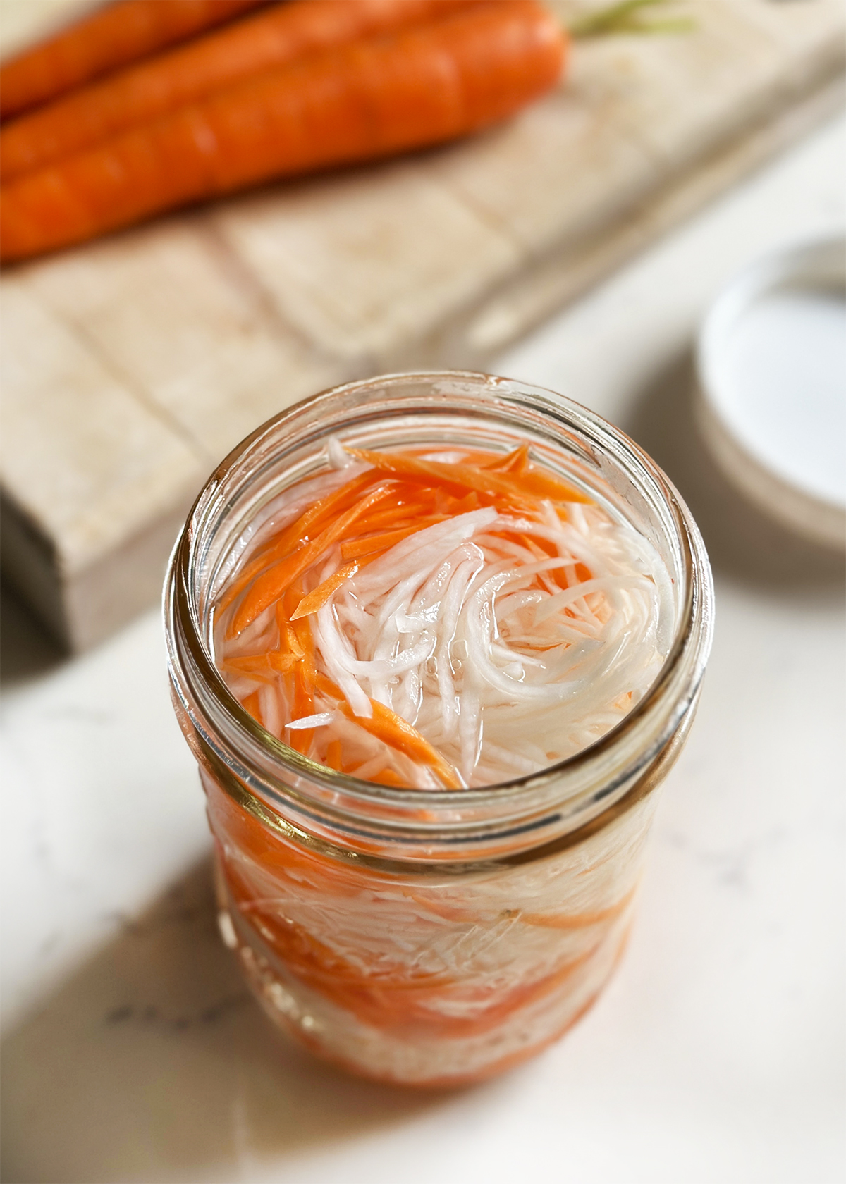 pickled daikon radish and carrots in glass jar