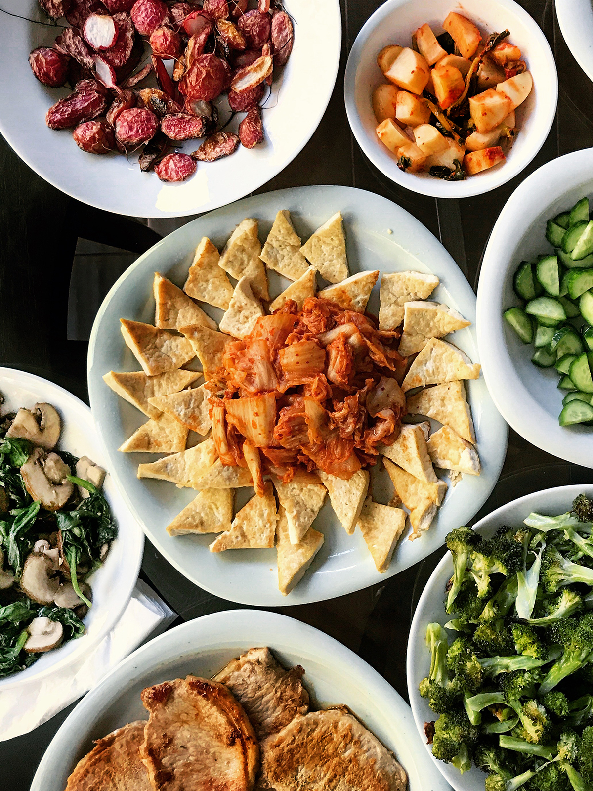 kimchi tofu and banchan on dinner table