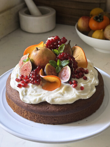 pumpkin olive oil cake with cream cheese frosting and fruit top