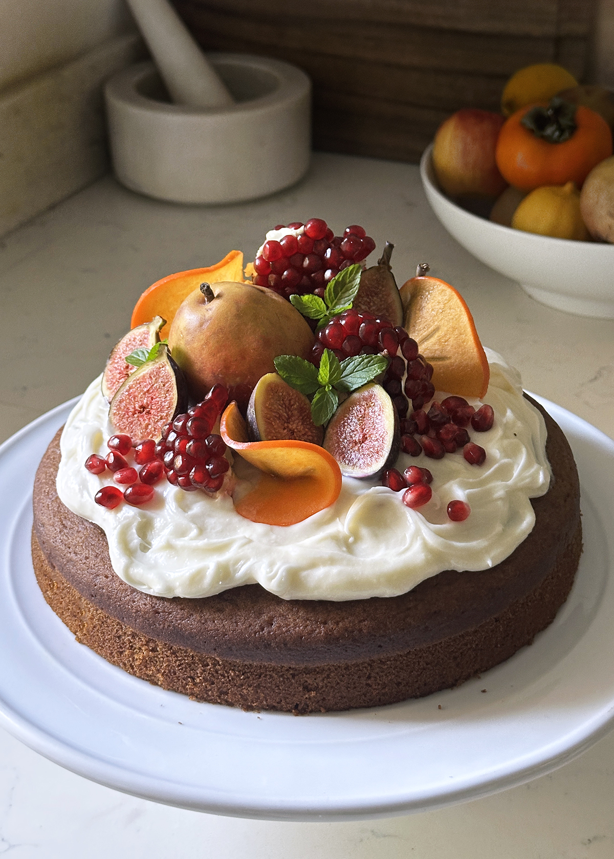 pumpkin olive oil cake with cream cheese frosting and fruit top