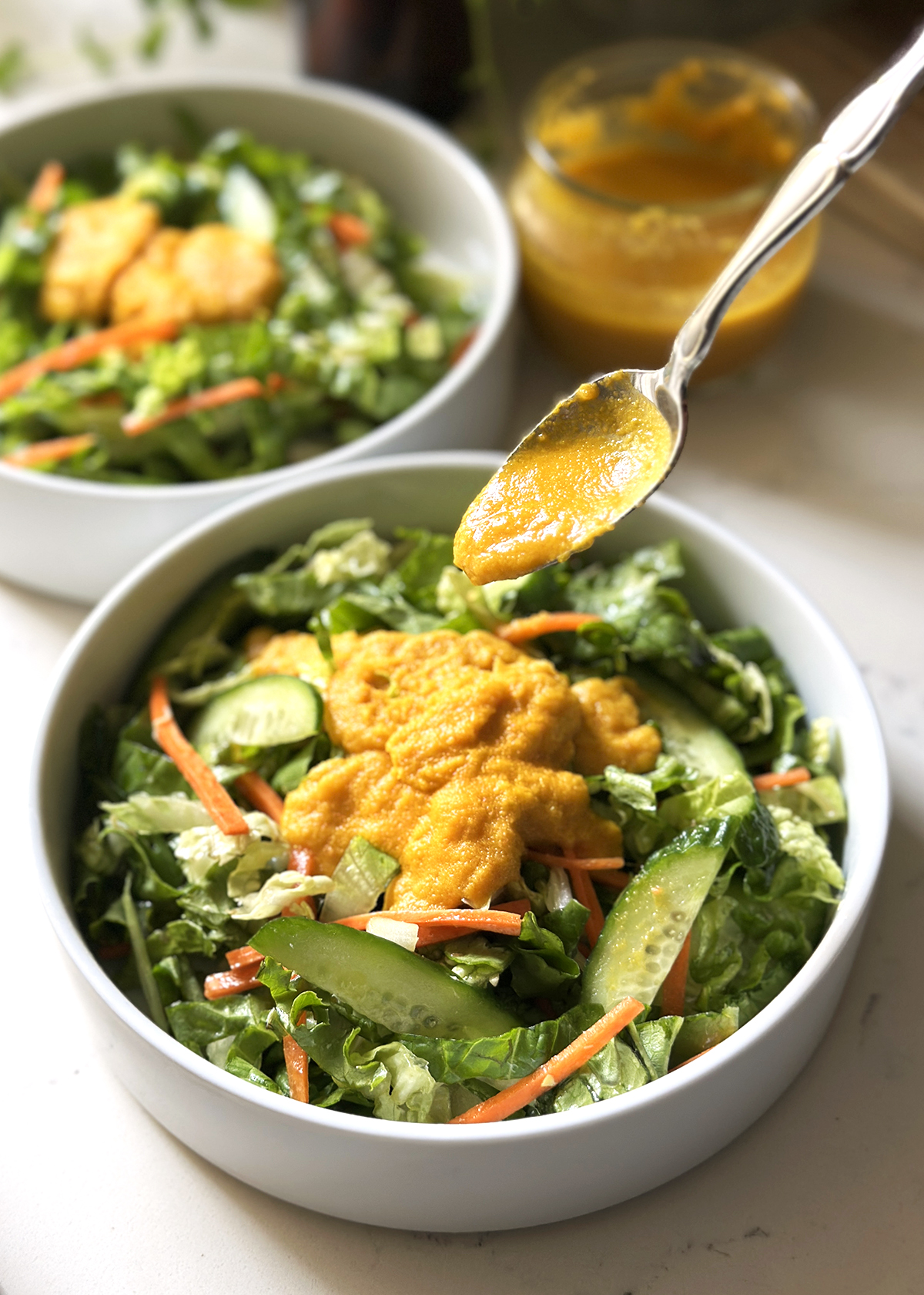 carrot ginger dressing spoon over salad