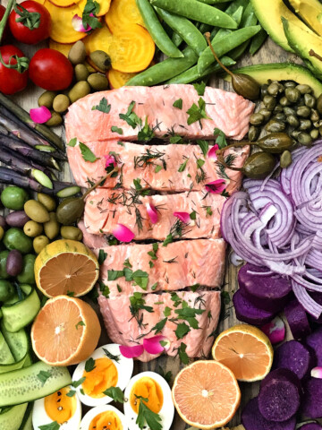 poached salmon garnished with rose herbs and rose petals with salad