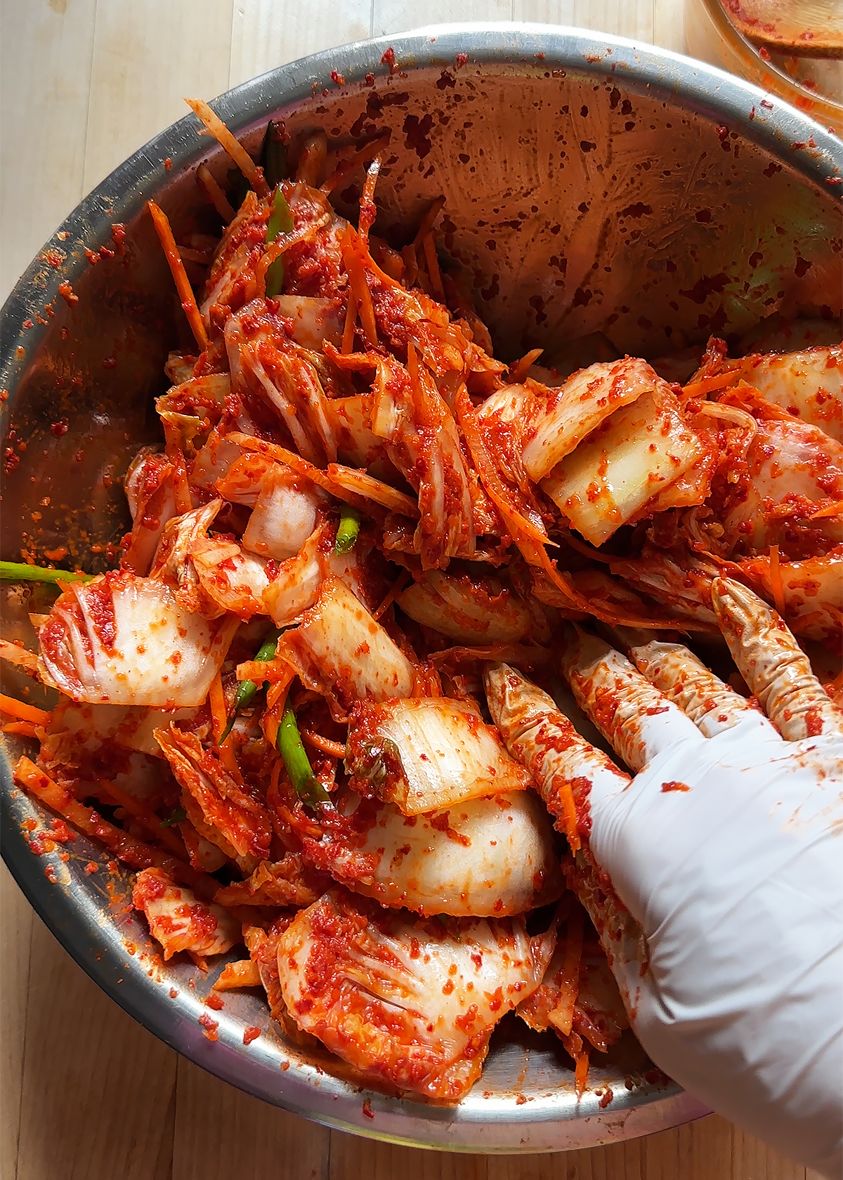 mixing kimchi vegetables by hand