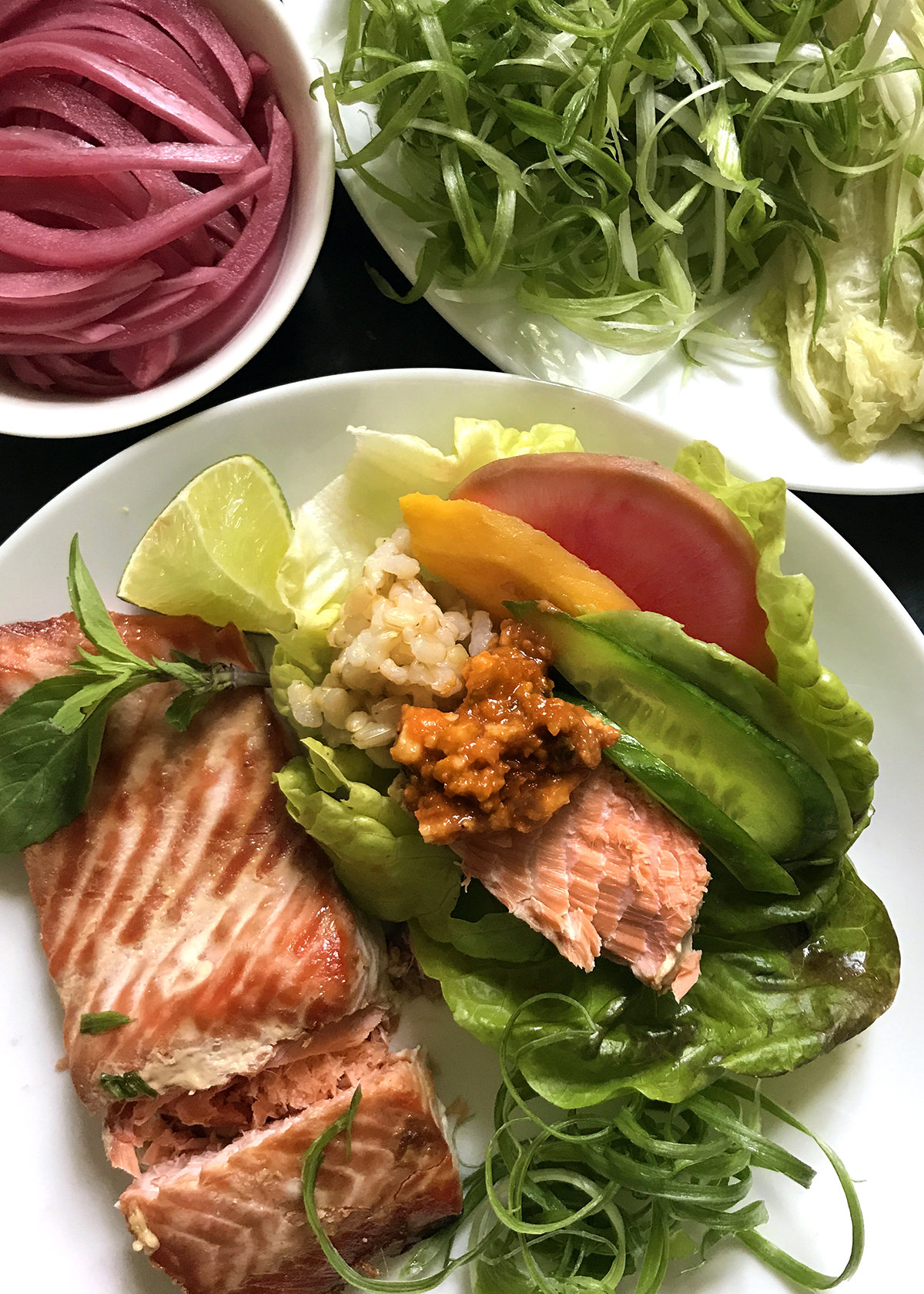 Ssam Jang with rice and salmon in lettuce wrap