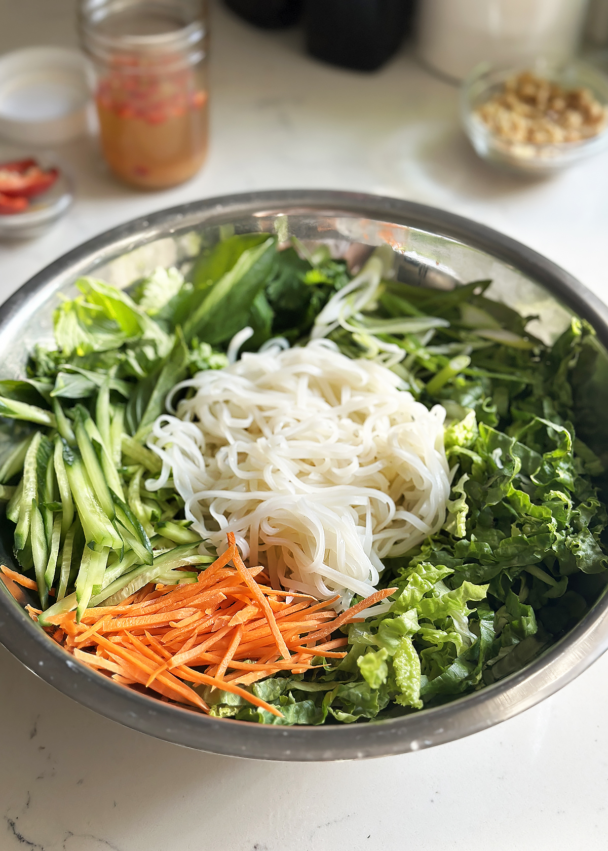 vietnamese rice noodle salad ingredients in mixing bowl