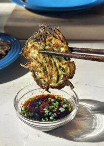 korean zucchini pancake in dipping sauce