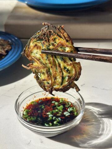 korean zucchini pancake in dipping sauce