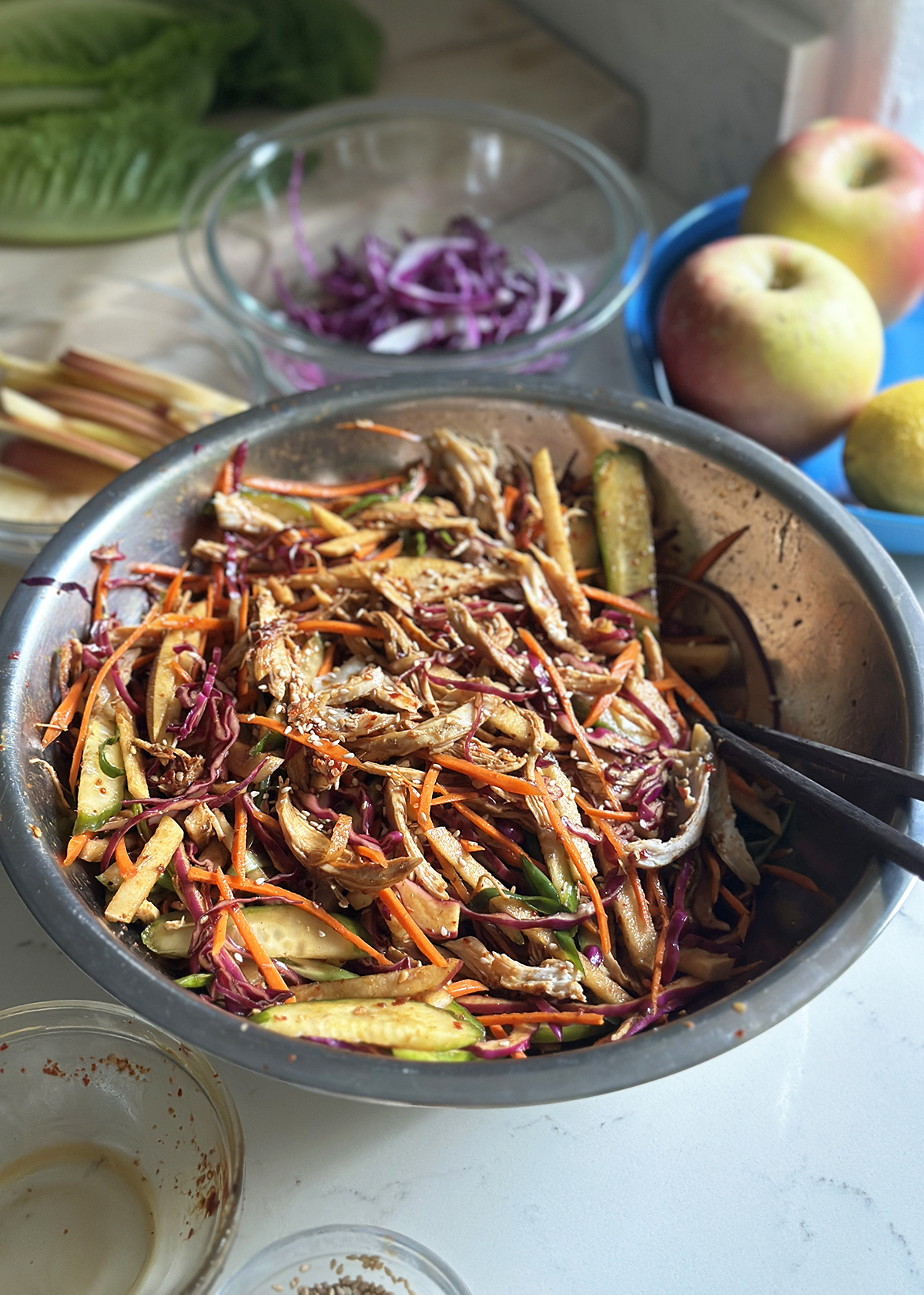 korean spicy chicken salad mixed in stainless steel bowl