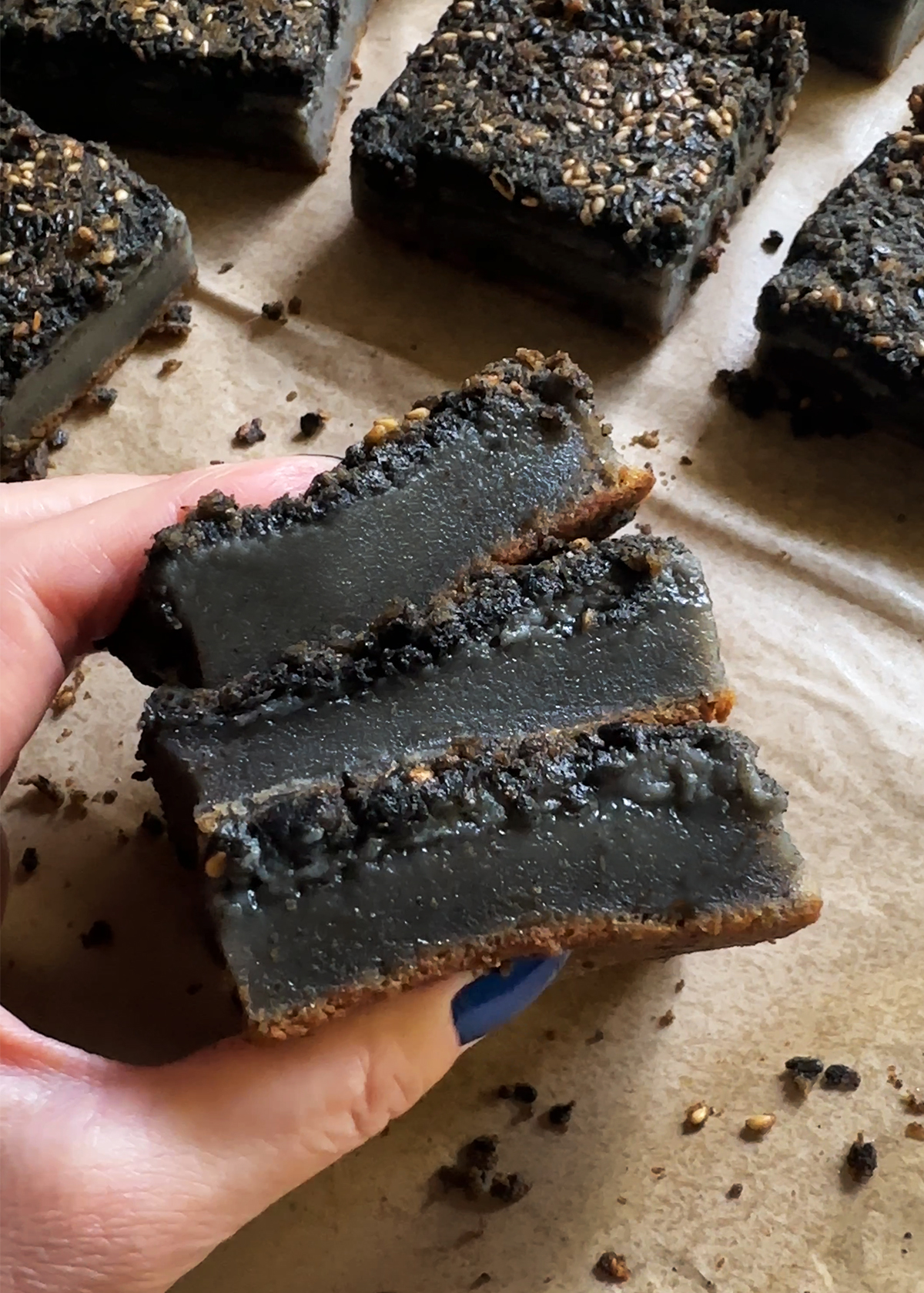 black sesame mochi cake pieces in hand
