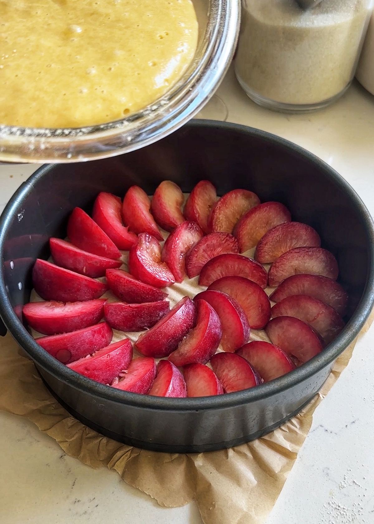 sliced plum in cake pan