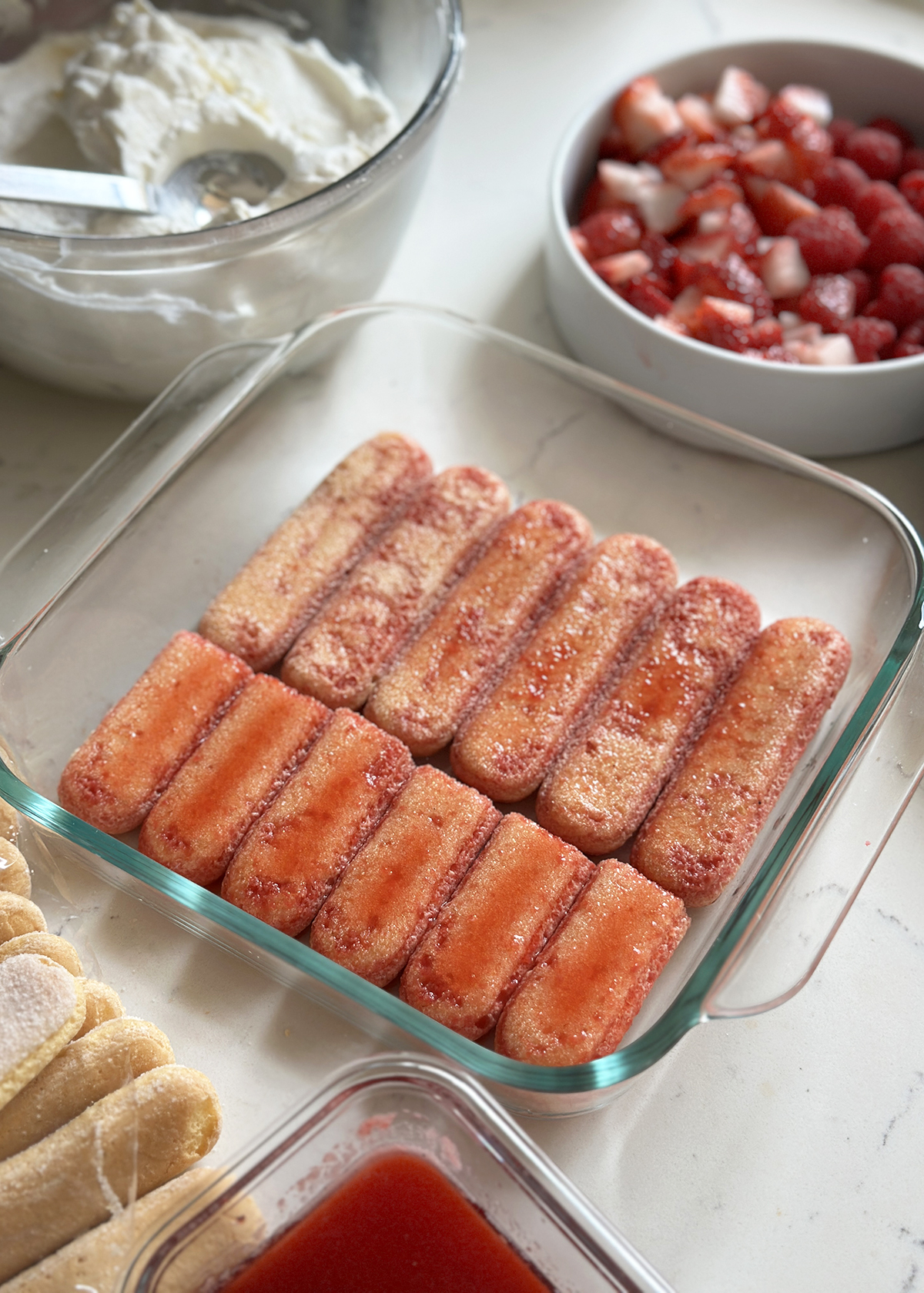 bottom layer ladyfingers in berry tiramisu