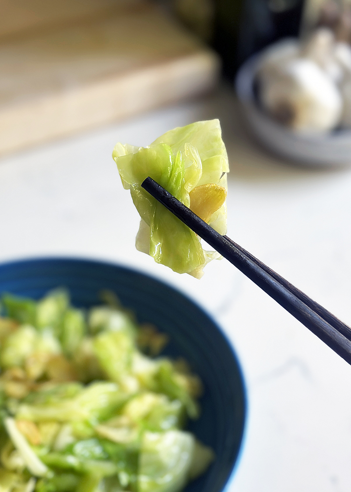 garlic sauteed cabbage piece on chopsticks