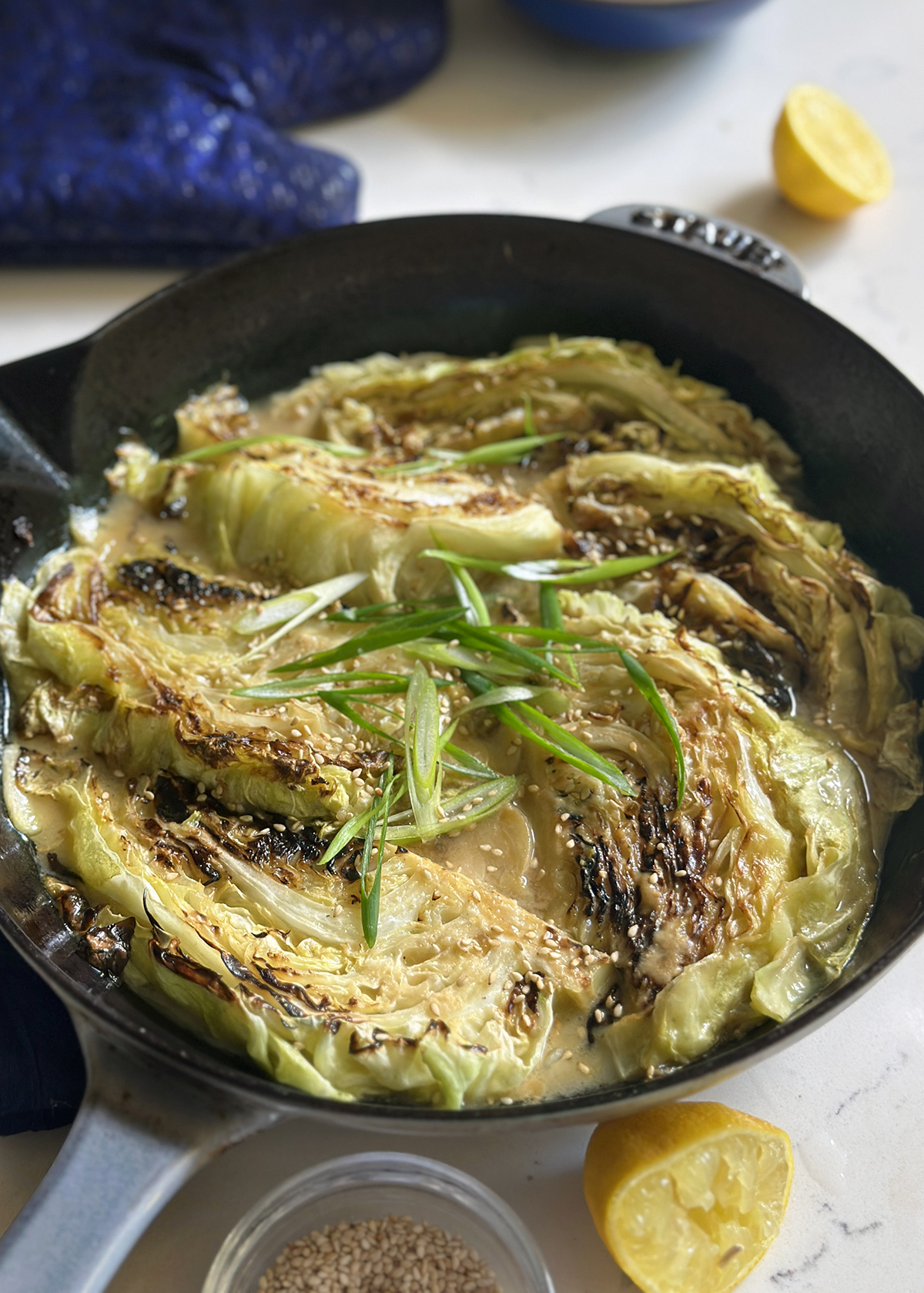miso butter braised cabbage, in pan garnished