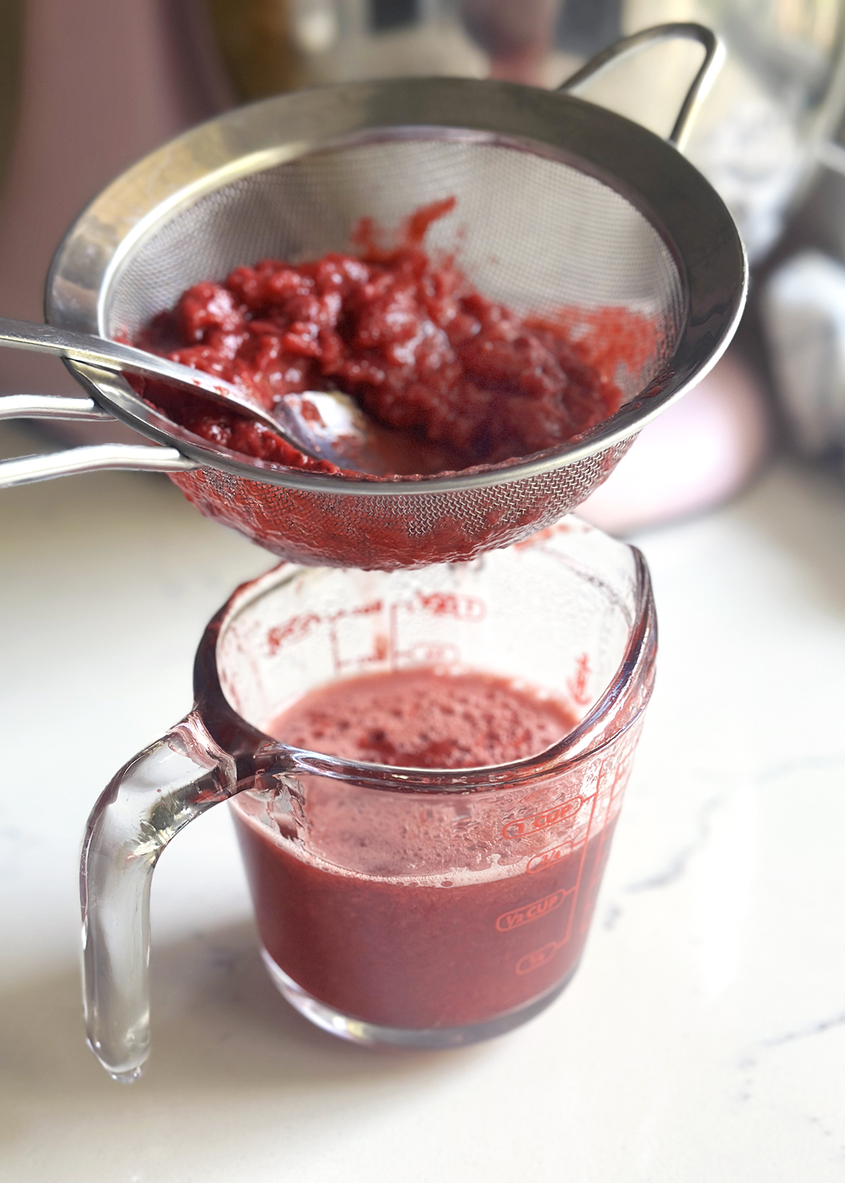 straining strawberry syrup
