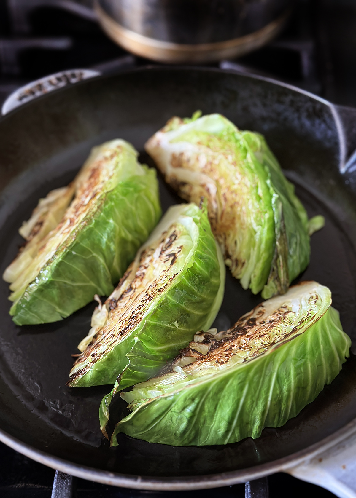 charred cabbage wedges in skillet