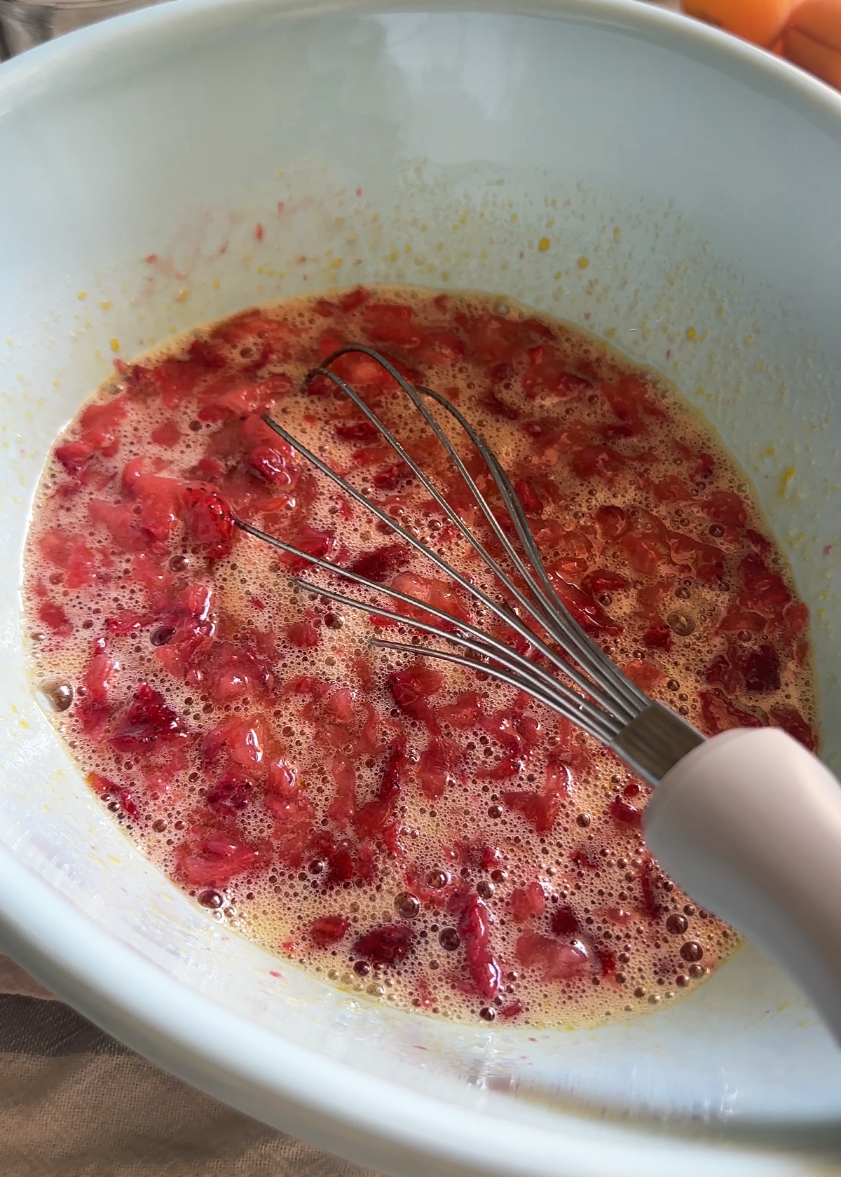 mashed strawberries in cake batter